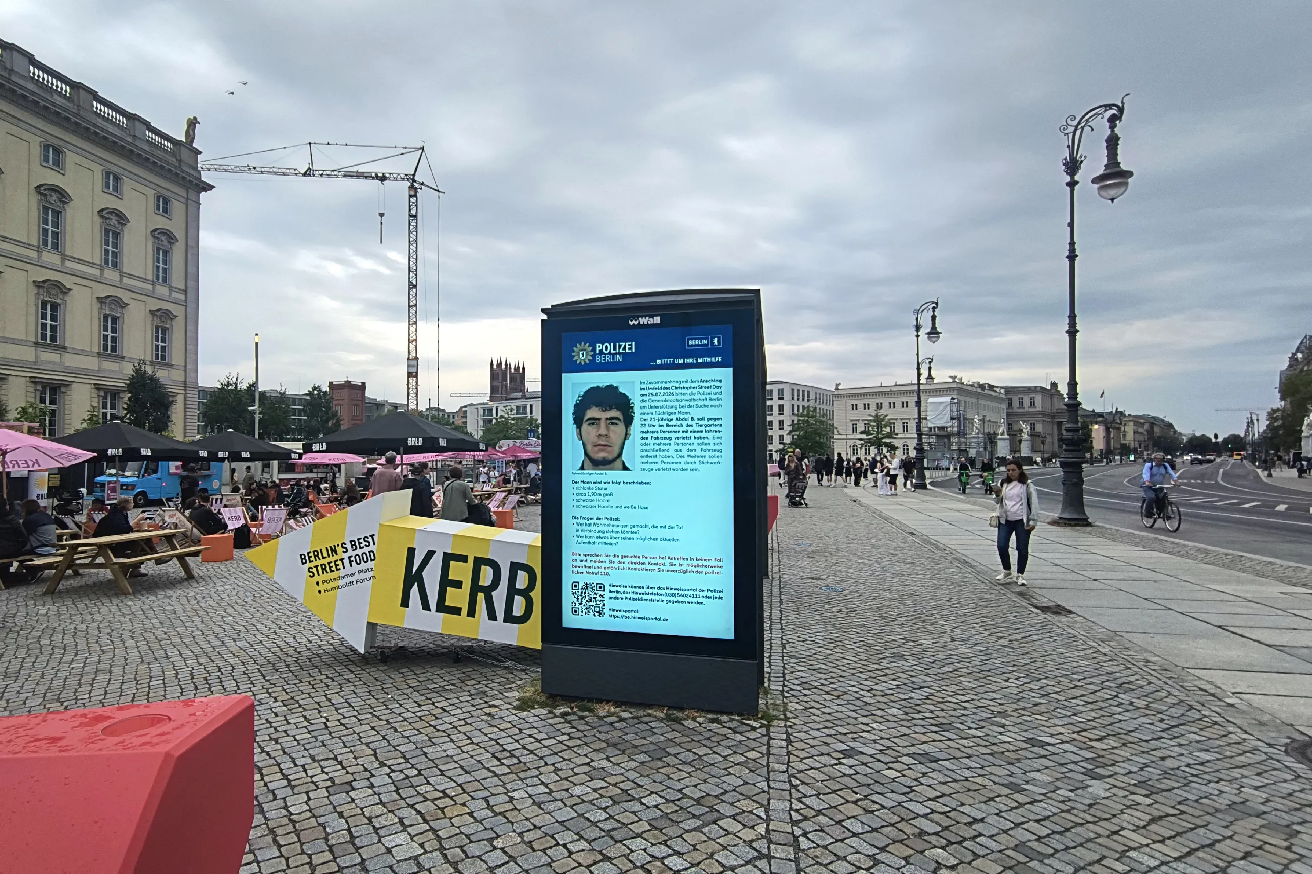 Bus stop display showing photo of Abdul Ballout on July 26, 2026.