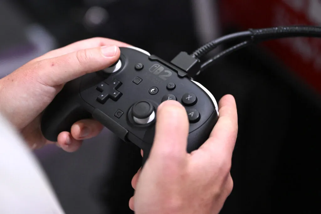 A gamer with a controller at a gaming booth